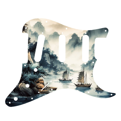 Egyedi Fender Stratocaster gitár koptató festői tájképpel, hegyekkel, fákkal és hagyományos vitorlás hajókkal a nyugodt vízen