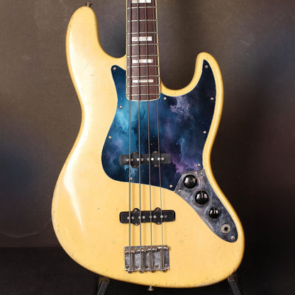 Egyedi Fender Jazz Bass gitárkoptató kozmikus mintázattal, kékes-lilás árnyalatokkal és csillagokkal díszített galaxis hatással