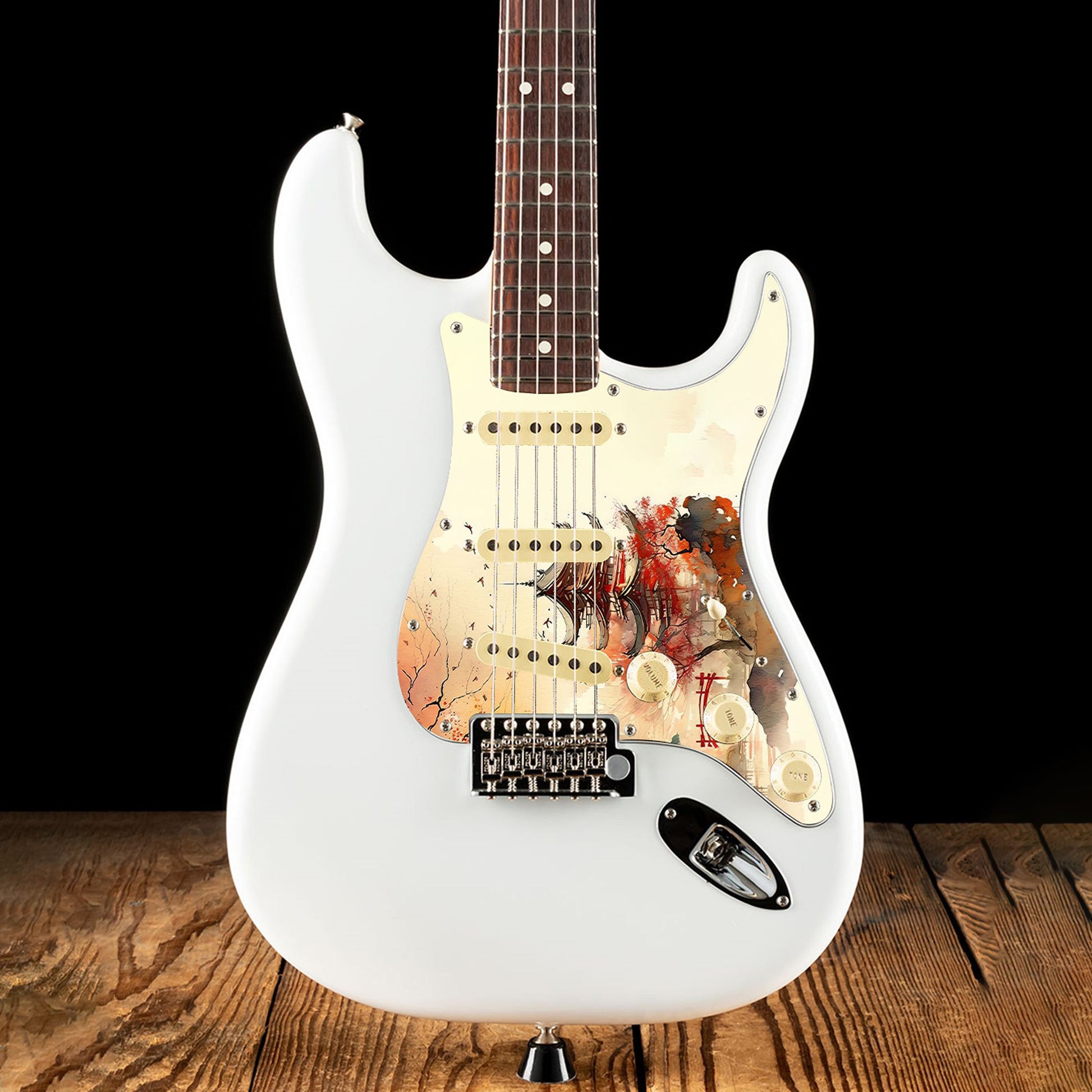 Egyedi Fender Stratocaster gitár koptató vörös pagodával, őszi lombú fákkal és madárrajjal a narancsos égbolt alatt