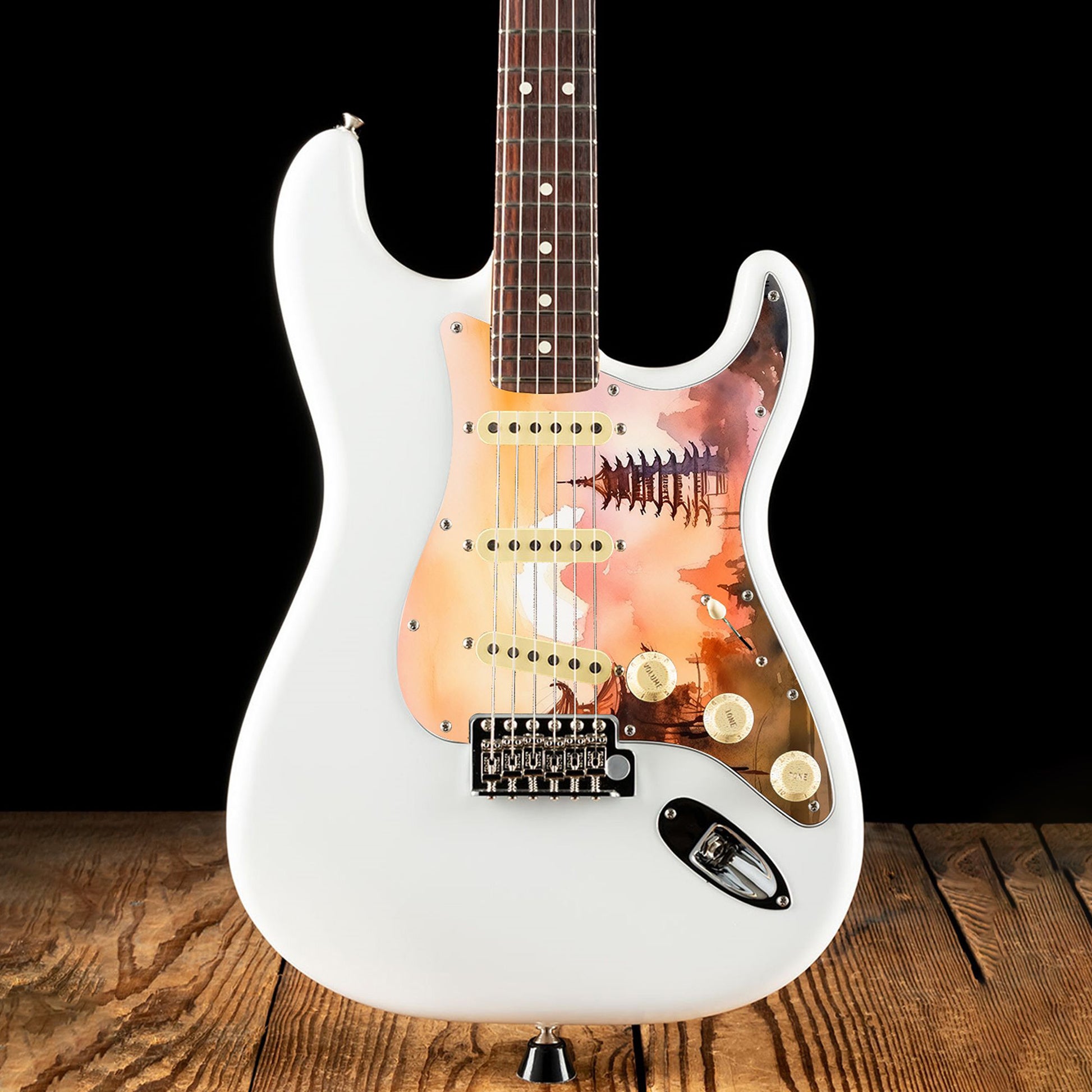 Egyedi Fender Stratocaster gitár koptató naplemente árnyalataival, hagyományos pagodákkal és hegyvonulatokkal a háttérben