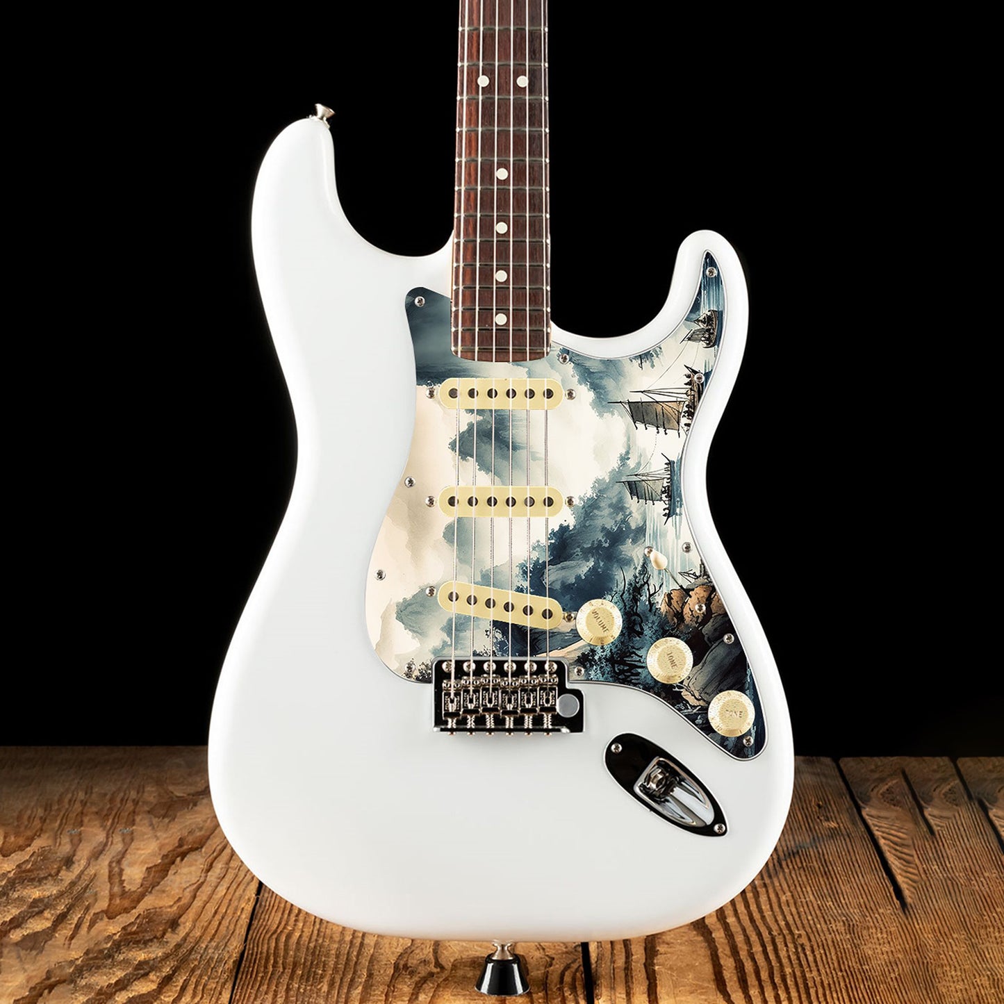 Egyedi Fender Stratocaster gitár koptató festői tájképpel, hegyekkel, fákkal és hagyományos vitorlás hajókkal a nyugodt vízen