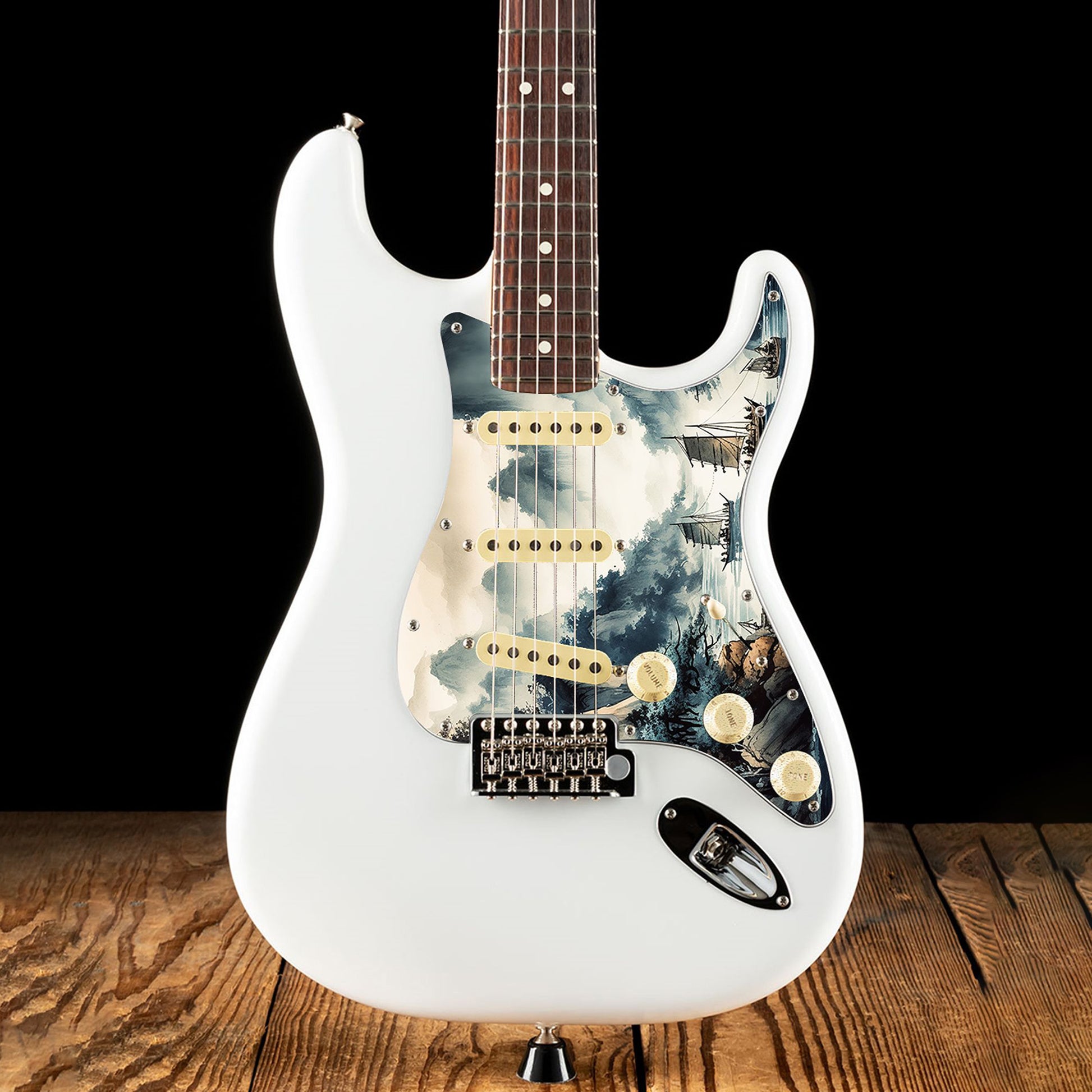 Egyedi Fender Stratocaster gitár koptató festői tájképpel, hegyekkel, fákkal és hagyományos vitorlás hajókkal a nyugodt vízen