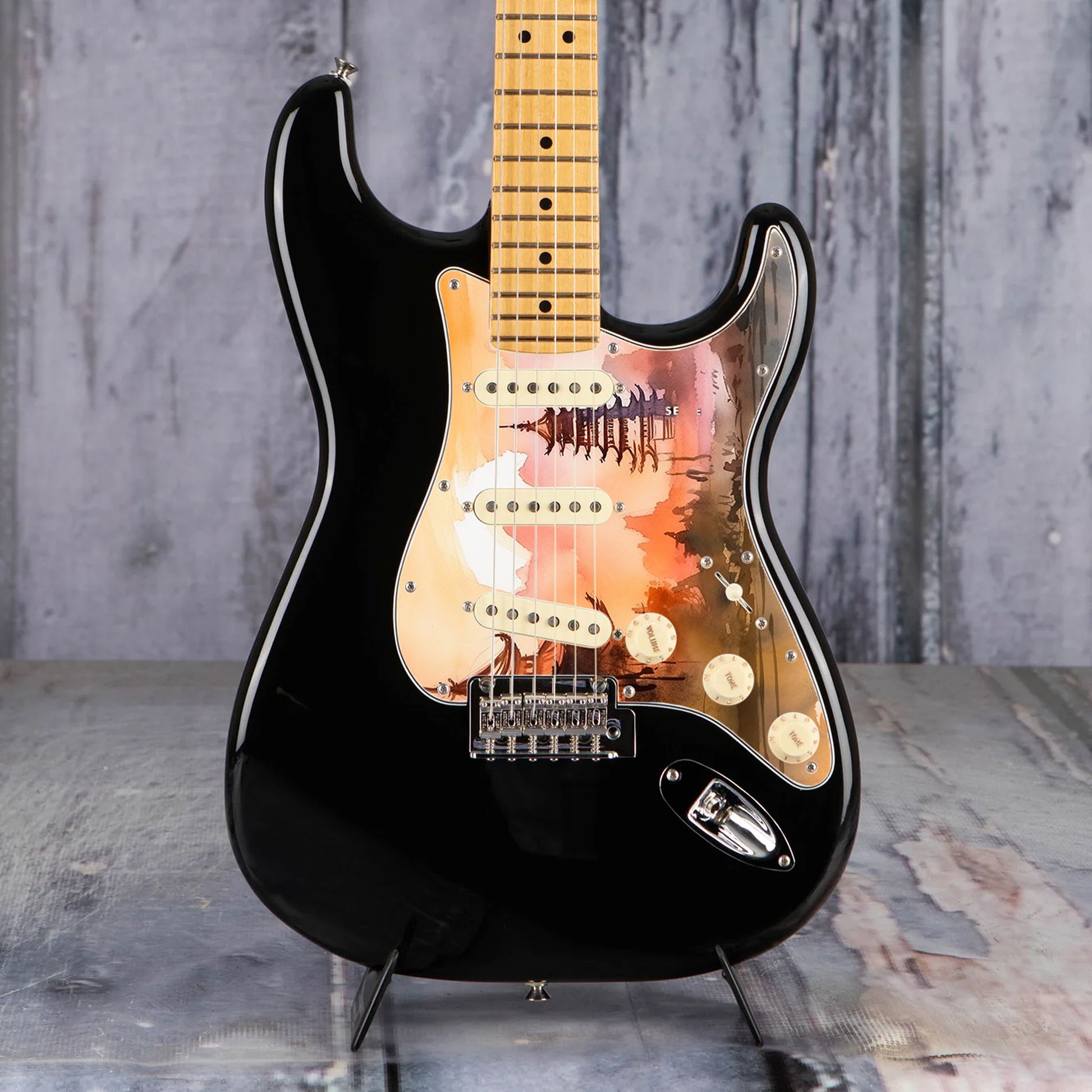 Egyedi Fender Stratocaster gitár koptató naplemente árnyalataival, hagyományos pagodákkal és hegyvonulatokkal a háttérben