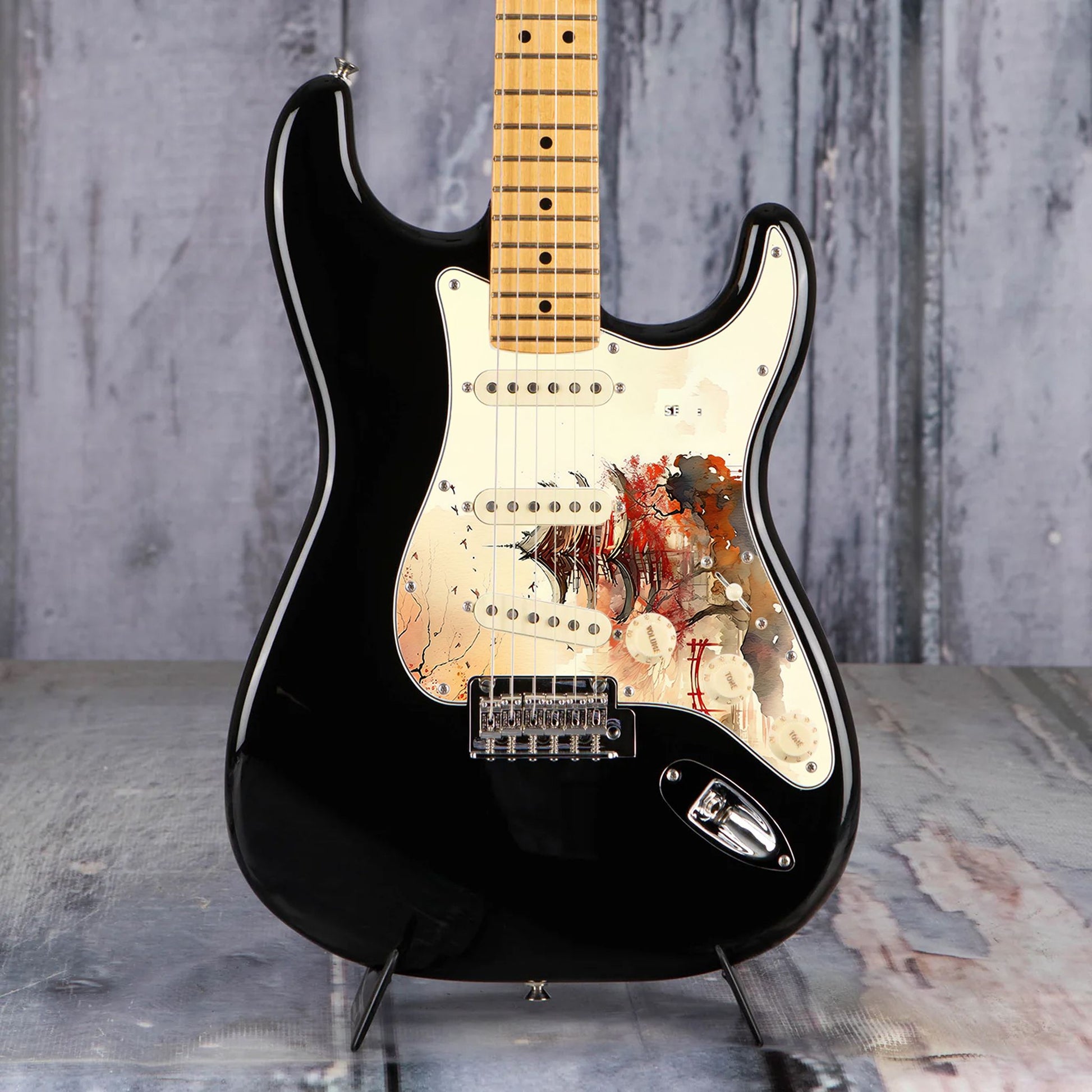 Egyedi Fender Stratocaster gitár koptató vörös pagodával, őszi lombú fákkal és madárrajjal a narancsos égbolt alatt