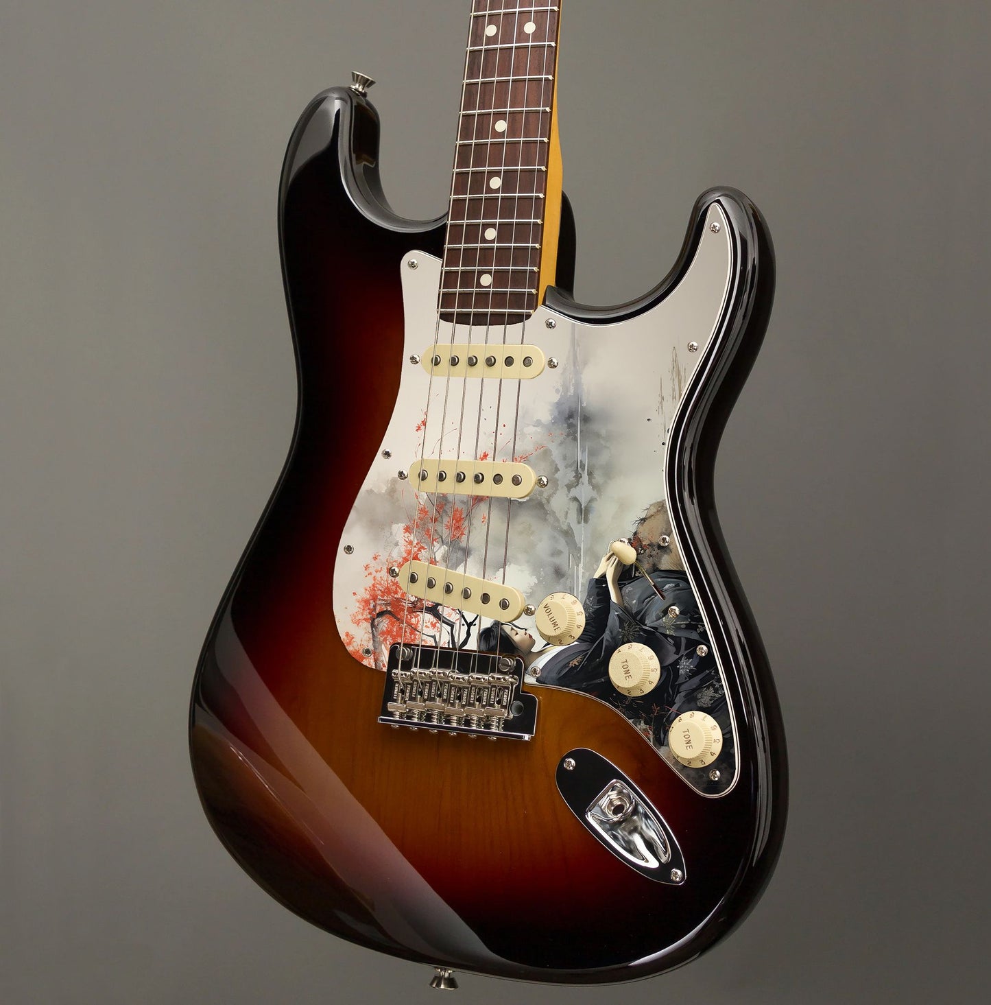 Egyedi Fender Stratocaster gitár koptató japán nőalak ábrázolásával, fekete kimonóban, vörös levelű fa alatt ülve a folyóparton