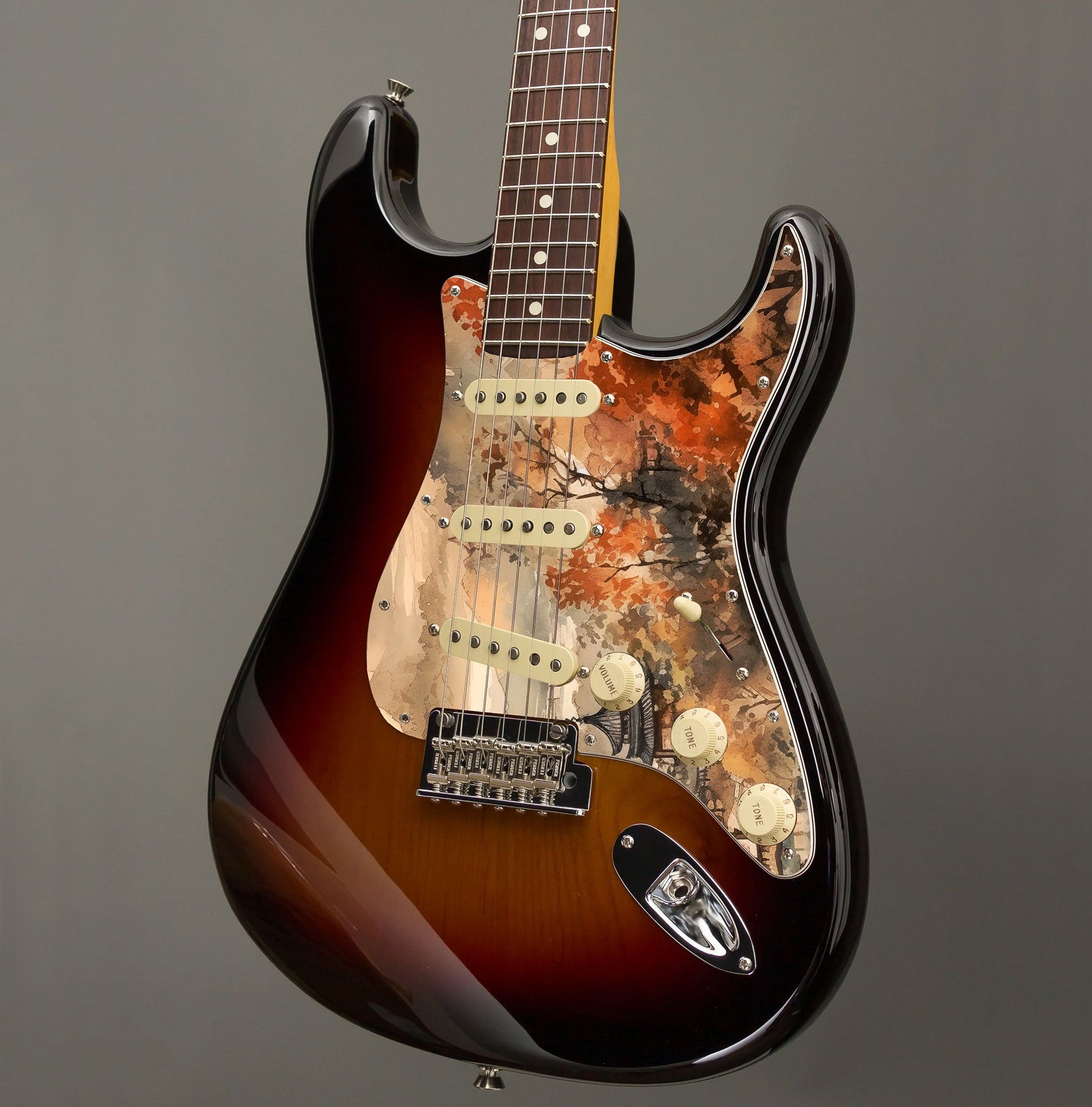 Egyedi Fender Stratocaster gitár koptató őszi színekben pompázó fákkal, hagyományos pagodákkal és ködbe burkolózó hegyekkel