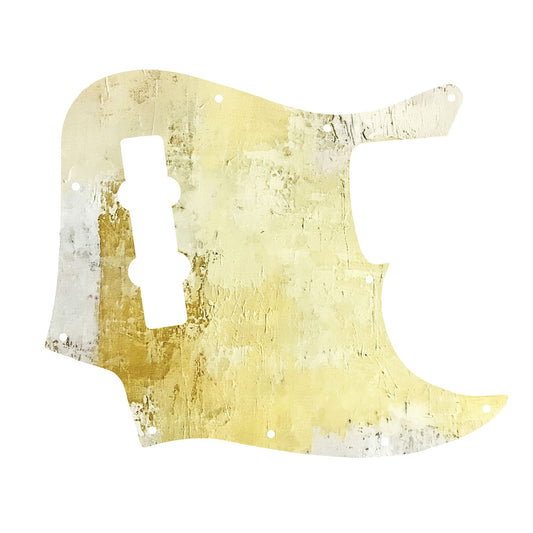 Egyedi Fender Jazz Bass gitár koptató meleg sárga és törtfehér árnyalatokkal, enyhén repedezett textúrával és egyedi megjelenéssel